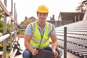 man fixing a tiled roof Recommended Roofers Dublin